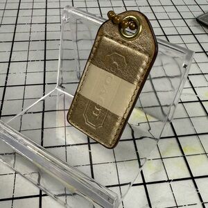 Coach Gold and Cream Leather Keychain. 2 by 1 inch with chain